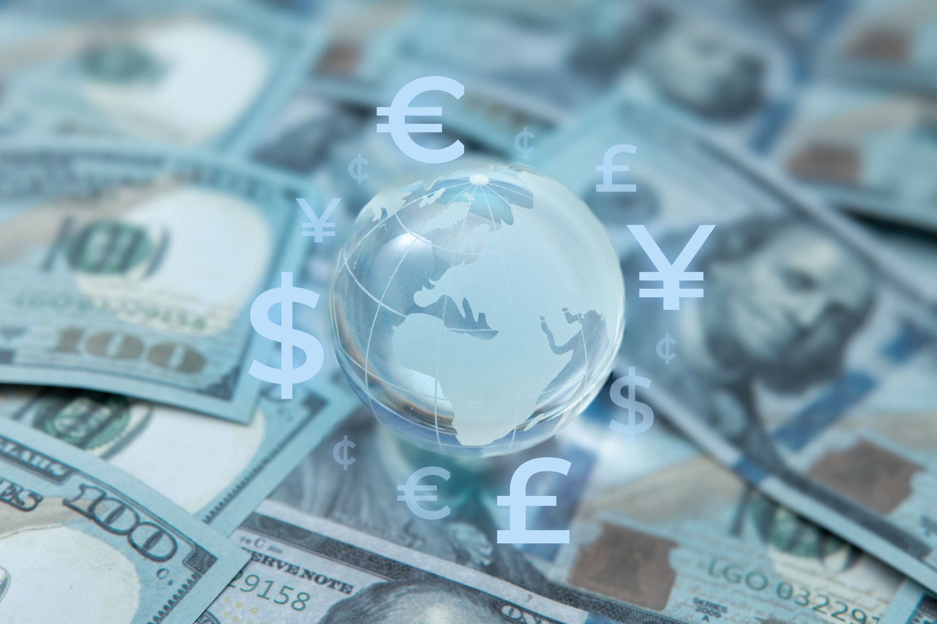 A globe surrounded by various international currency symbols.
